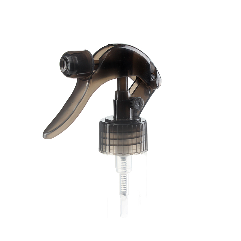 45-degree angled view of translucent black mini trigger sprayer showing nozzle and lockable button, 28-410 neck, fine mist spray, 0.5 ml dosage