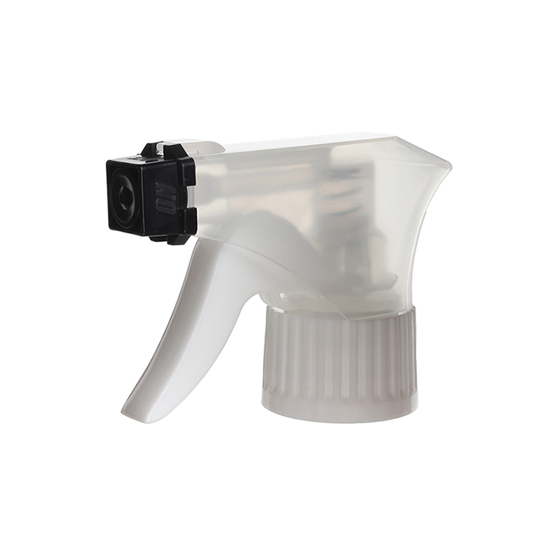 45-degree angled view of clear and white child-resistant trigger sprayer showing spray-only nozzle and safety lock design, 28-410 neck, 0.6 ml dosage